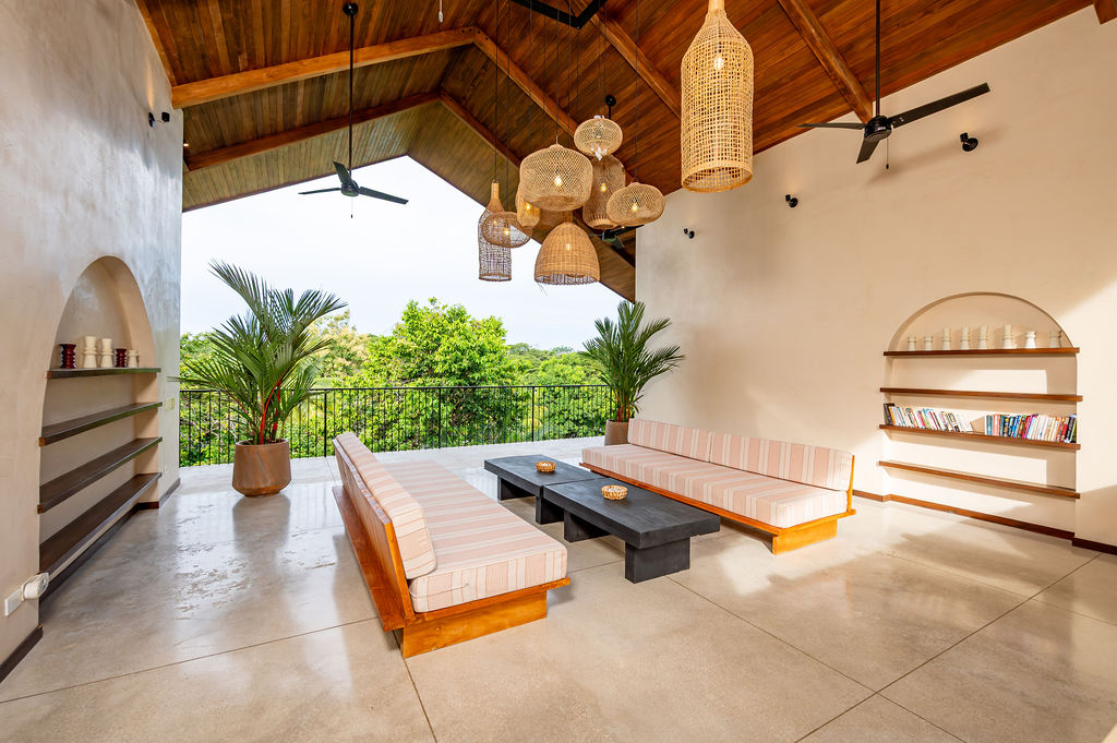 The third-floor room looking out to the balcony and the treetops