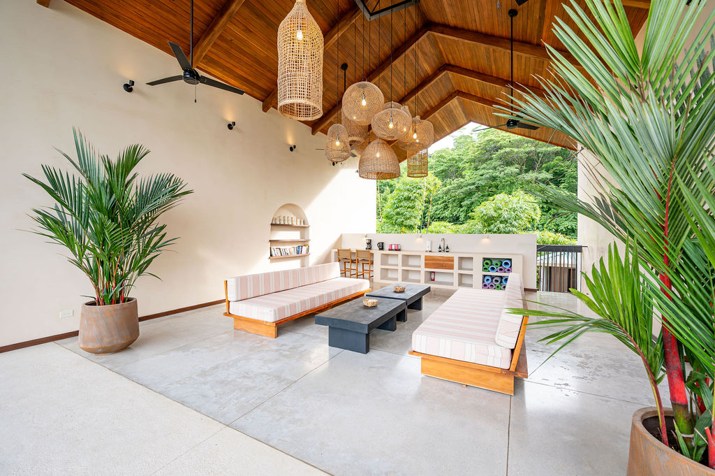 The A-frame teak ceiling with rattan pendants above the loungers