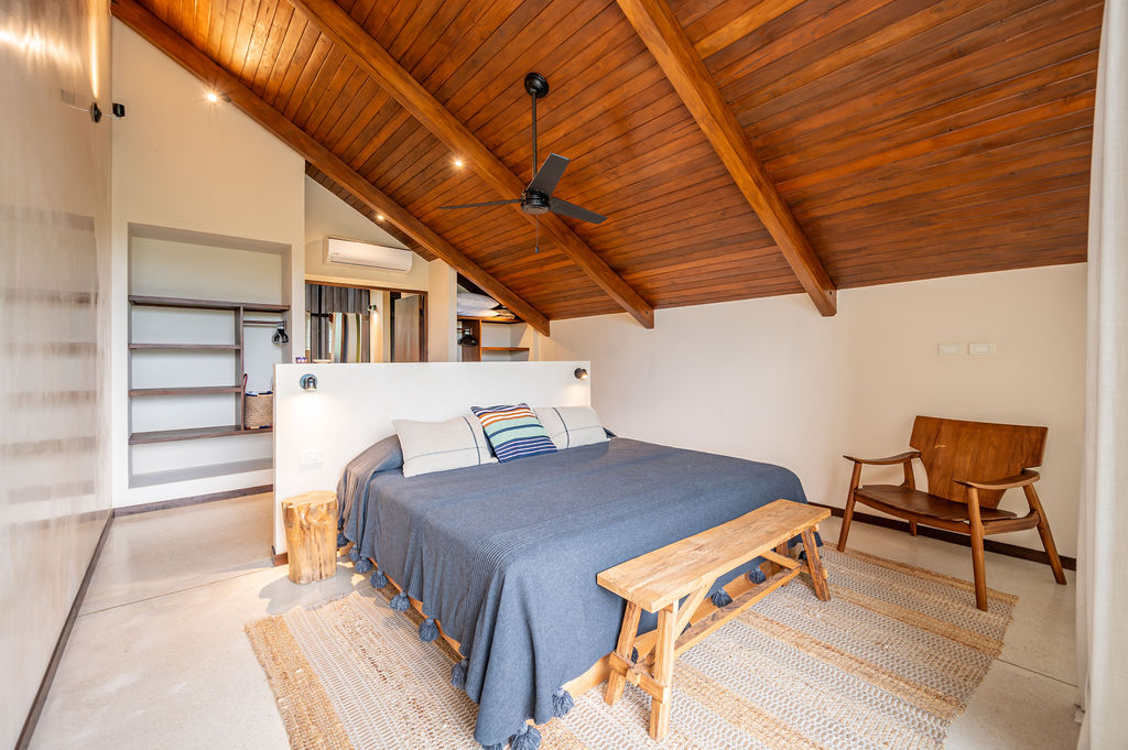 Gable suite with a king bed beneath the pitched timber ceiling