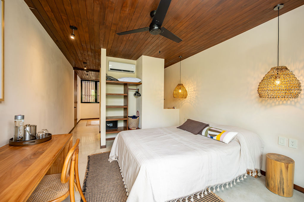 Suite One — open wardrobe shelving and brass wall light
