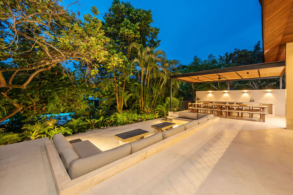 The sunken terrace lounge and lit pergola bar at blue hour